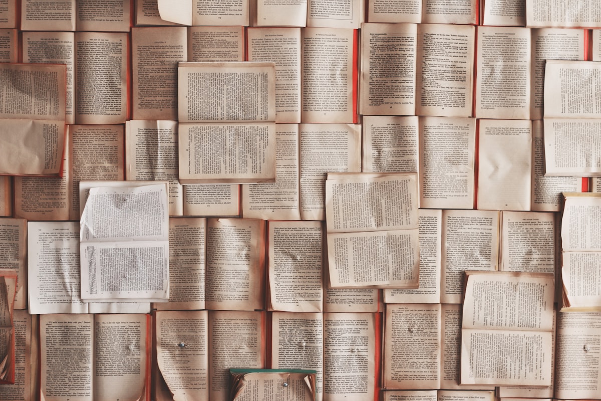 Hands turning pages of a bound newspaper volume at the reading table